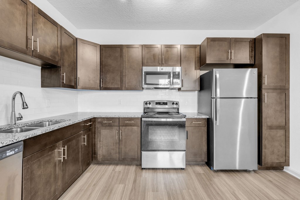 a kitchen with stainless steel appliances and wooden cabinets