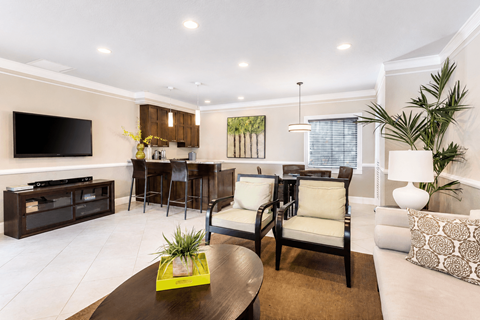 A modern living room with a brown coffee table and a white couch.