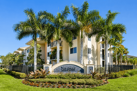A large white building with a sign that says "Venetian" in front of it.