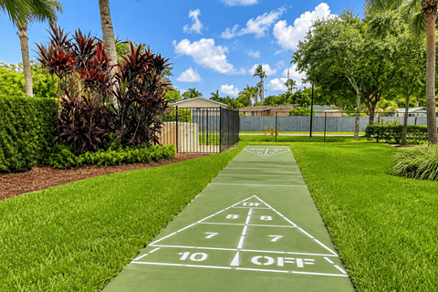 A green lawn with a hopscotch game painted on it.