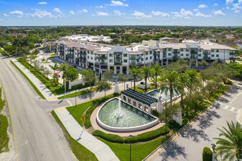 an aerial view of the resort properties with a fountain in the middle of a grassy area