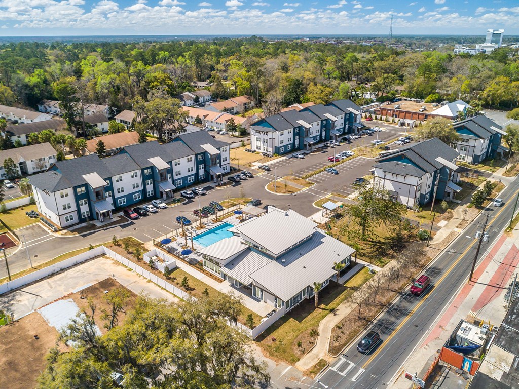 arial view of a neighborhood of houses with a pool in the middle of the road