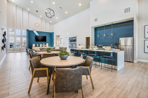 A modern dining room with a round table and chairs.