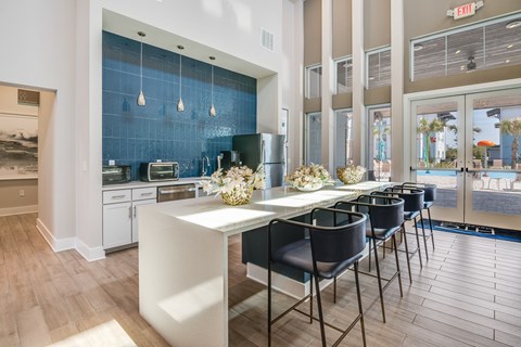A kitchen with a table and chairs in front of a blue backsplash.