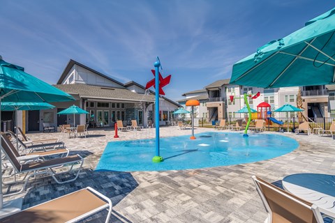 A pool area with a blue umbrella and a red flag.