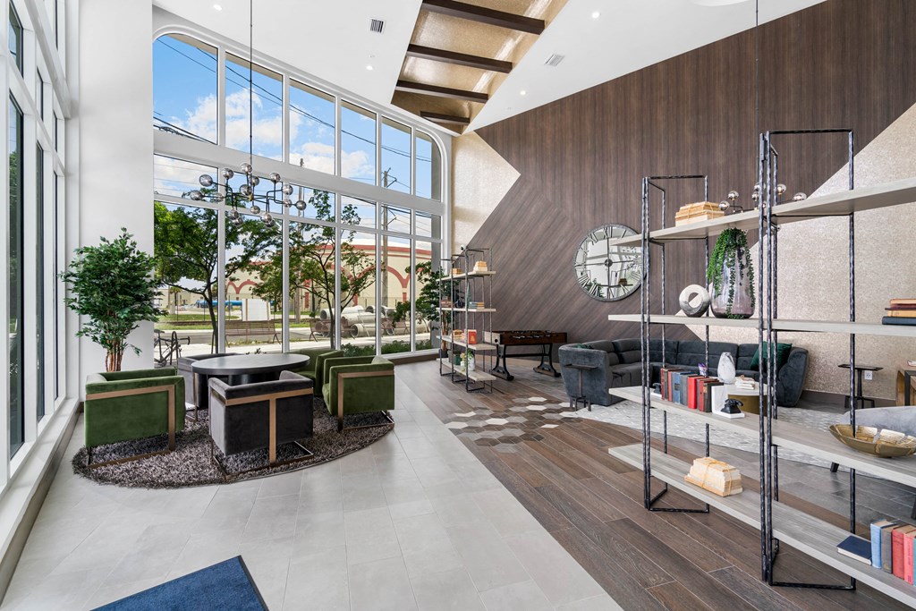 a living room with a large window and a clock on the wall