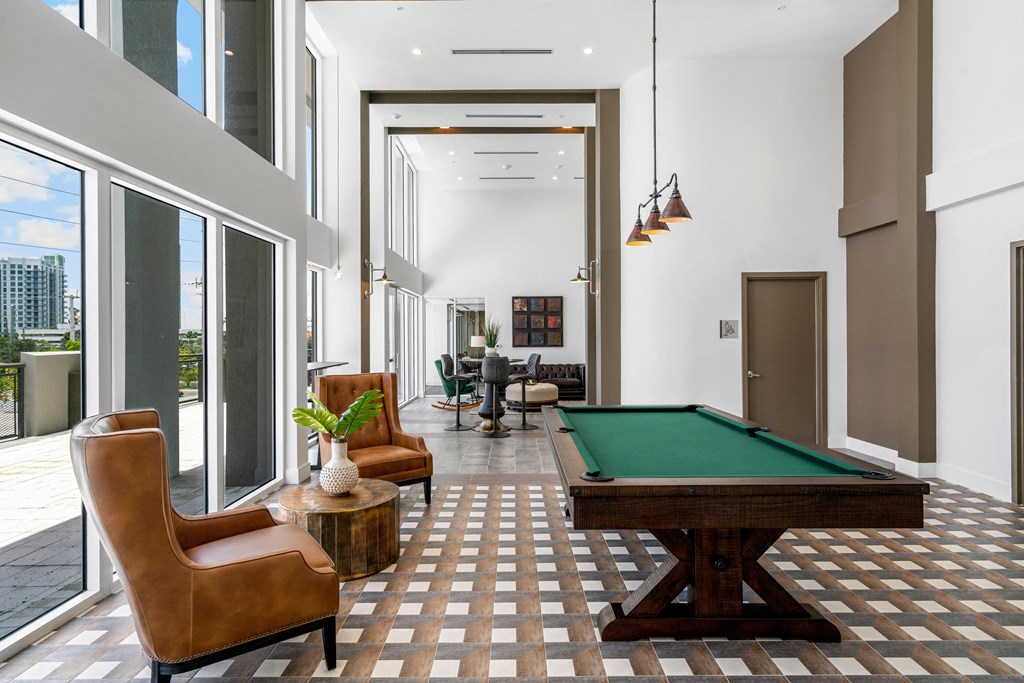 a living room with a pool table in the middle