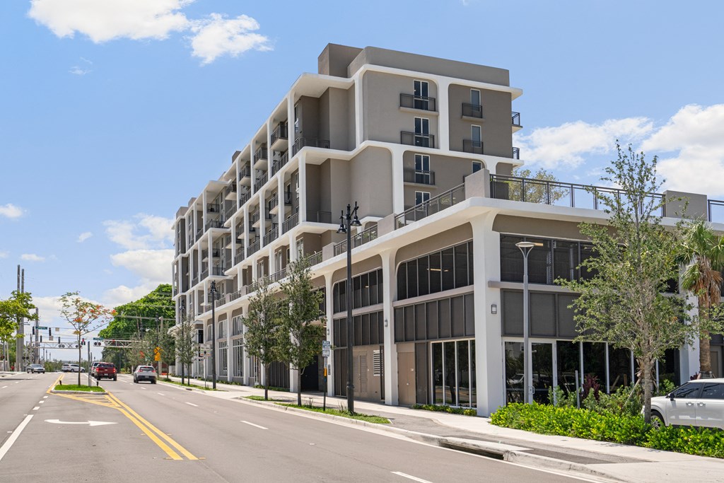a large apartment building on the corner of a city street
