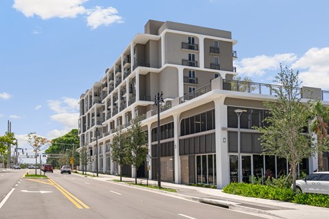 a large apartment building on the corner of a city street