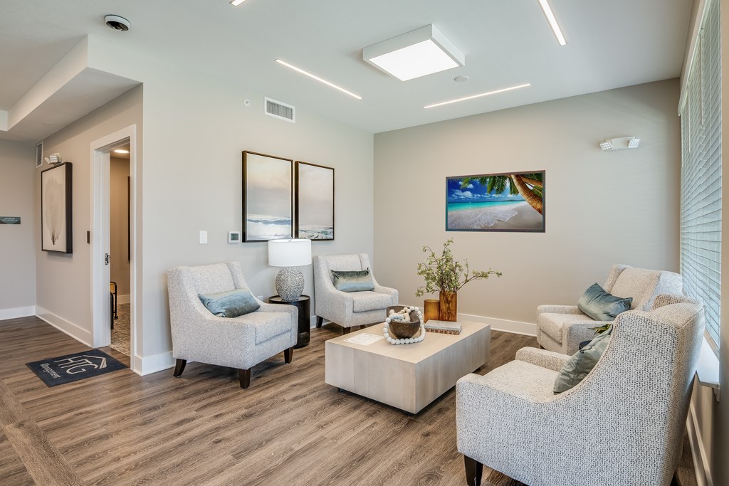 A living room with a couch, chair, and a coffee table.
