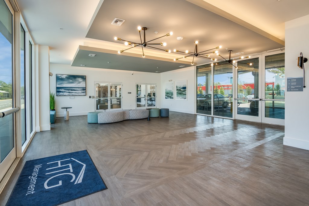 A room with a blue rug on the floor and a ceiling fan.