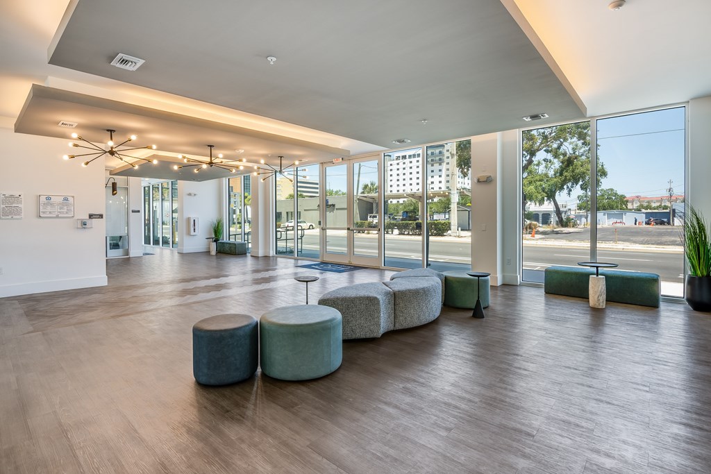 A spacious room with a long table and chairs.