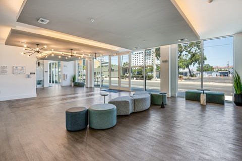 A spacious room with a long table and chairs.