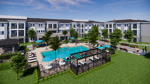 A large swimming pool surrounded by a fence and chairs is in the foreground of a residential area.