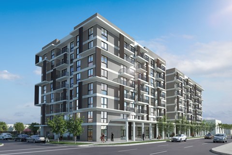 A modern multi-story residential building with balconies and multiple windows.