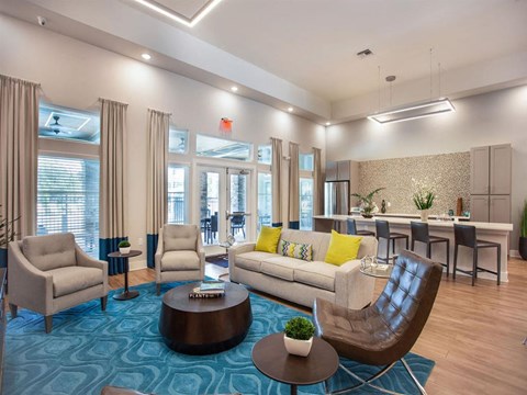 A living room with a blue carpet and furniture.