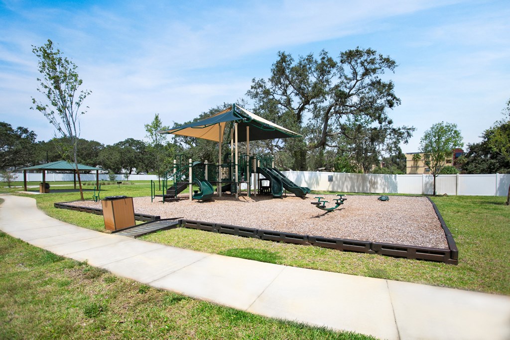 a playground with a swing set and a picnic table