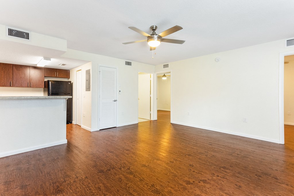 a living room with a ceiling fan and hardwood floors