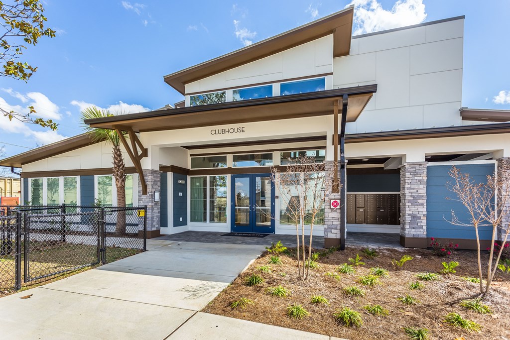 a building with a blue and white facade and a blue door with a do not enter sign