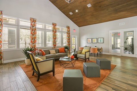 A living room with a couch, chairs, and a coffee table.