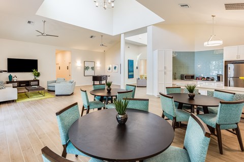 A modern dining room with a large table and chairs.