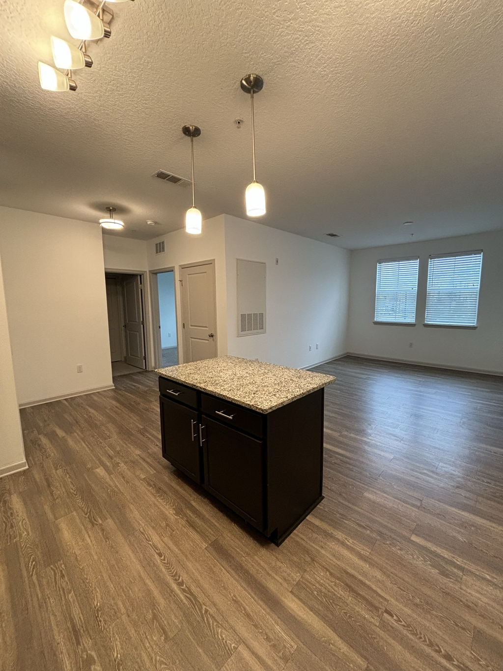 an empty living room with an island in the middle