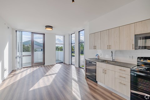 A modern kitchen with wooden cabinets and a stainless steel dishwasher.