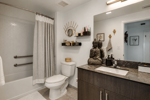 A bathroom with a toilet, sink, and shower.