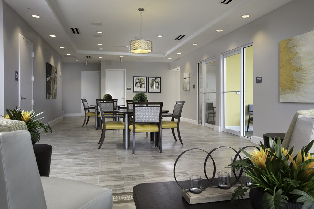 a resident clubhouse with a large table and chairs