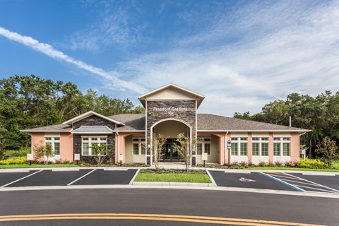 The front of a building with the words "Freedom Gardens" on it.