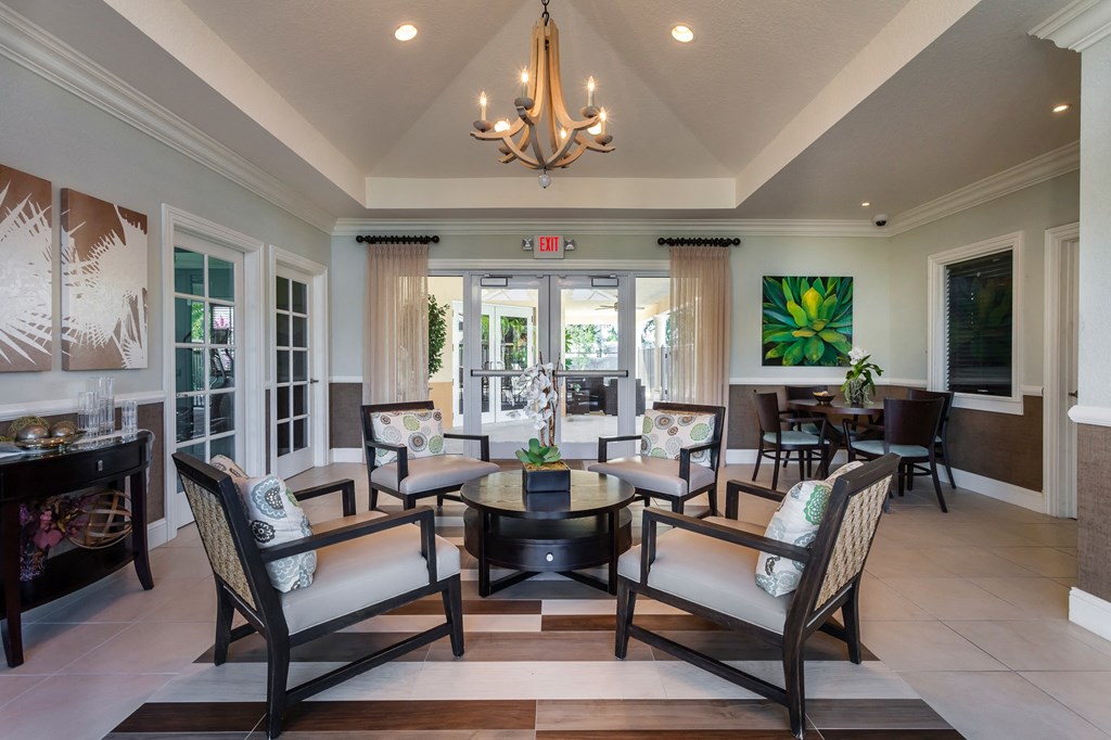 a living room filled with furniture and a chandelier