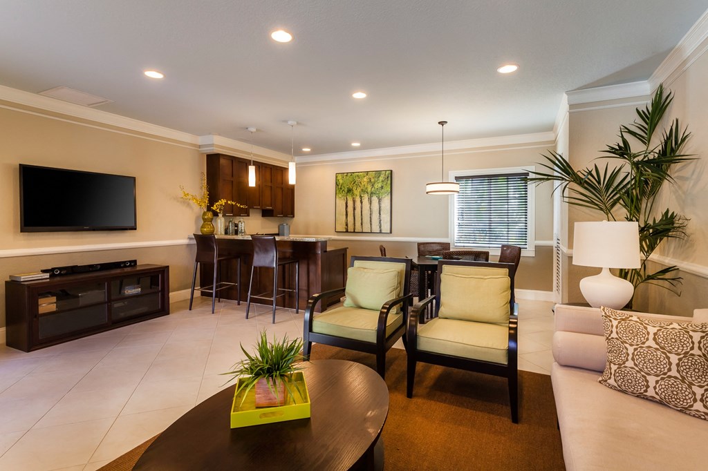 a living room filled with furniture and a flat screen tv