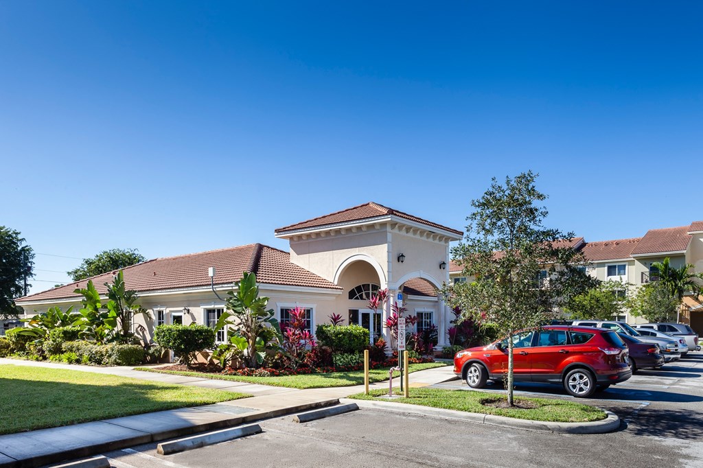 a house with a red car parked in front of it