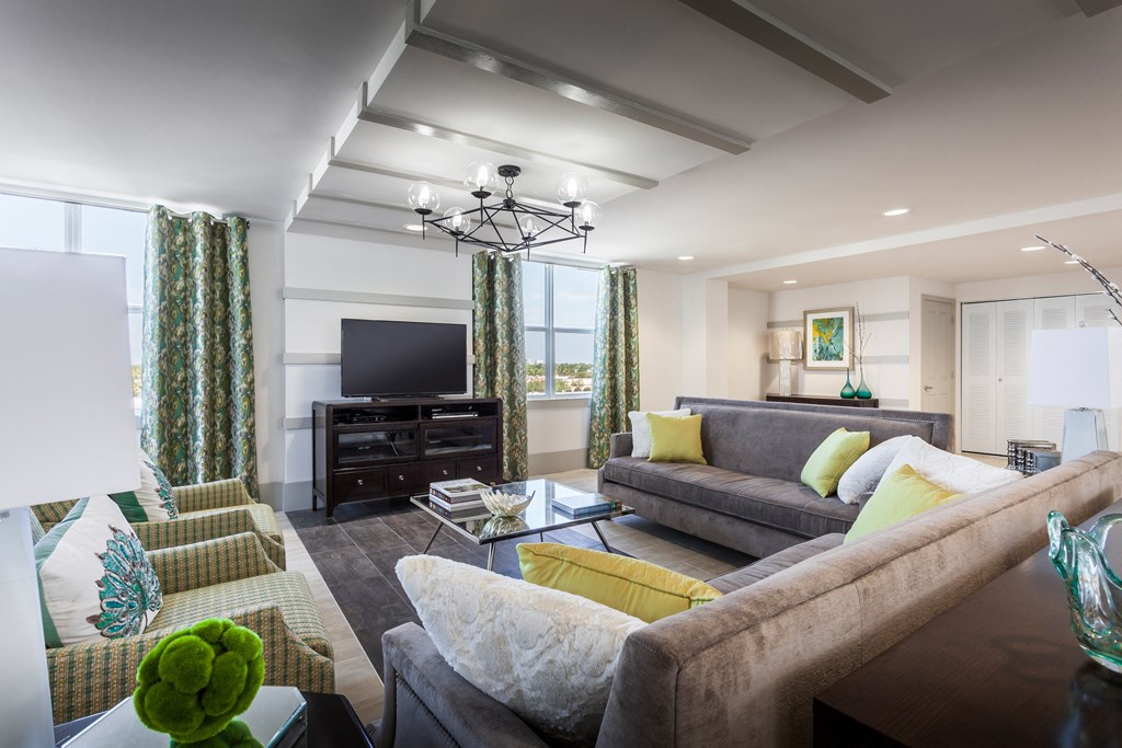 a living room filled with furniture and a large window