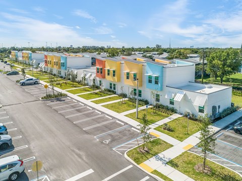 a row of colorful houses in a parking lot