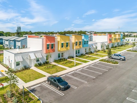 a row of colorful houses in a parking lot