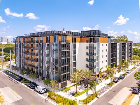A modern multi-story building with a mix of orange, gray, and black colors.