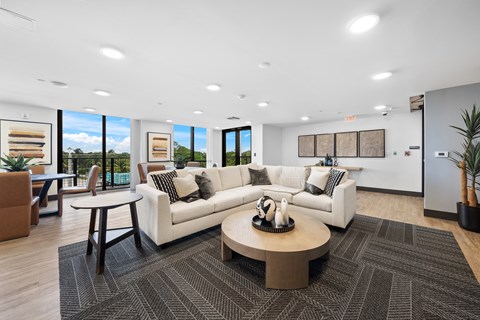 A modern living room with a white sofa and a coffee table.