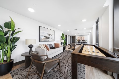 A living room with a pool table and a couch.