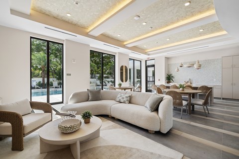 A modern living room with a large sectional sofa and a coffee table.