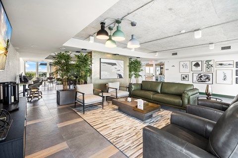A modern living room with a green couch and a wooden floor.