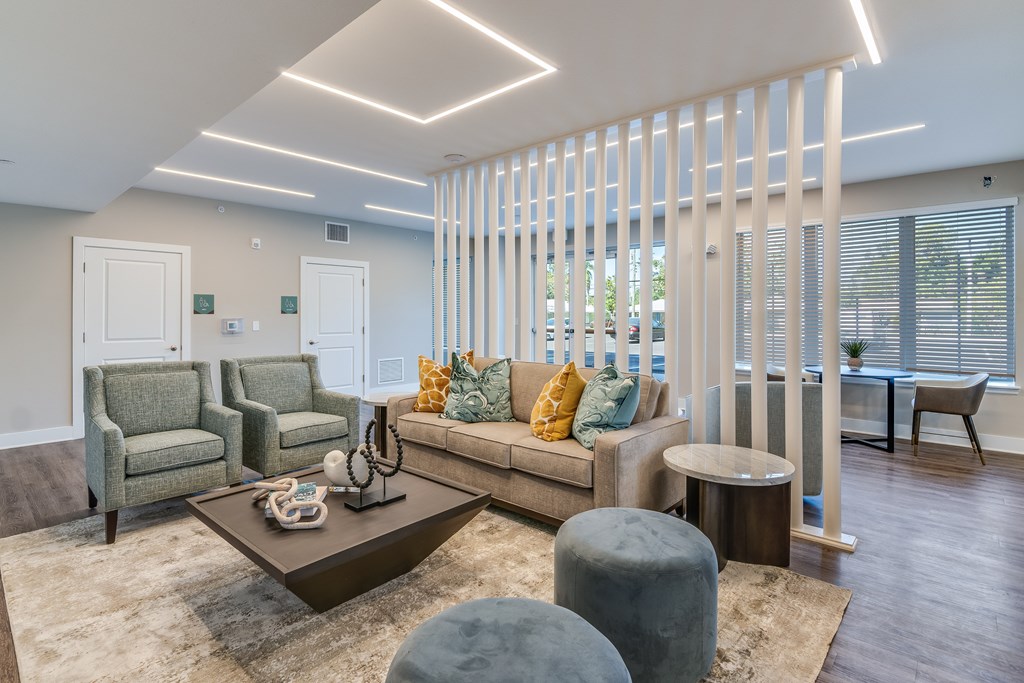 A living room with a couch, chairs, and a coffee table.