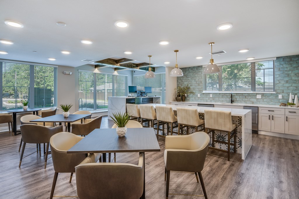 A modern dining room with a long table and chairs.