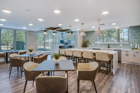 A modern dining area with a long table and chairs.