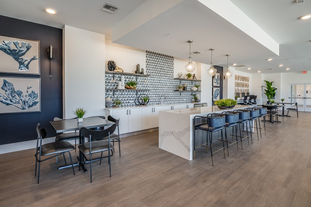 A modern dining area with a long table and chairs.