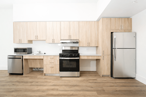 A kitchen with wooden cabinets and stainless steel appliances.
