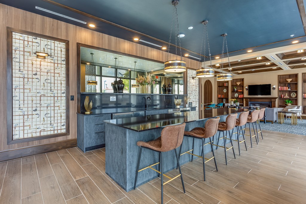 A modern kitchen with a bar area and seating.