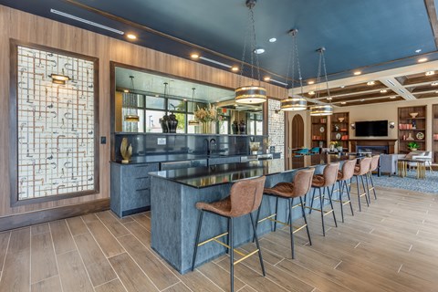 A modern kitchen with a bar area and seating.