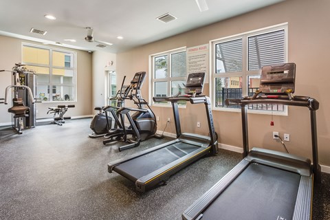 the gym with treadmills and exercise equipment at 1861 muleshoe road apartments
