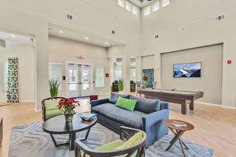A living room with a blue couch and a coffee table.